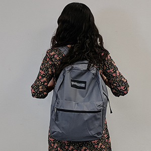 Rear view of child recipient of back to school back pack